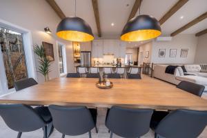 a dining room with a large wooden table and chairs at Ski in - Ski out - SPA & Pool Table - Le Konect in Saint-Philémon +31 photos