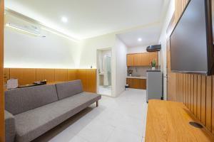 a living room with a couch and a tv at Bali True Living in Denpasar