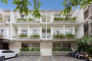 an apartment building with plants on the balconies at Bali True Living in Denpasar