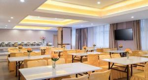 a conference room with tables and chairs and a flat screen tv at Vienna Hotel Guangxi Fangcheng in Fangcheng