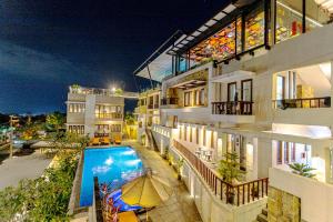 an apartment building with a swimming pool at night at Hilltops Serviced Apartment in Semarang