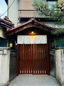 a brown garage door with a white curtain on it at Zen House - Tajimi in Tajimi