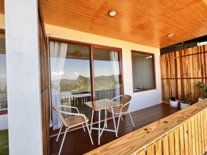 a balcony with a table and chairs on it at Oxygen-phamee in Ban Pha Mi
