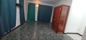 Una habitación vacía con cortinas azules y verdes. en Villa Accacia, en Trou aux Biches