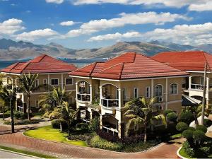 a row of houses with mountains in the background at Moonbay Marina the Villas in Olongapo