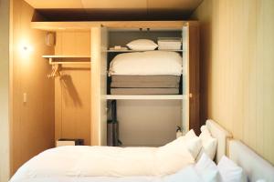 Un dormitorio pequeño con una cama en una habitación. en SANU 2nd Home 河口湖2nd, en Fujikawaguchiko