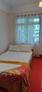 Ένα ή περισσότερα κρεβάτια σε δωμάτιο στο Nigaah Homestay By StayApart