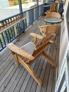 a wooden chair and a table on a deck at Waterview Motel Sussex Inlet in Sussex inlet +5 photos