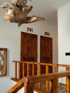 a room with two wooden doors with numbers on the wall at Dhiffushi Inn in Dhiffushi