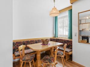 a dining room with a wooden table and chairs at Apartment in Mittersill with mountain view in Mittersill