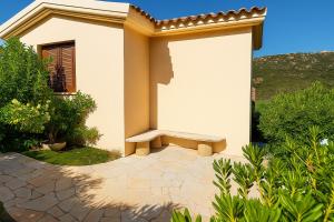 a small house with a bench in front of it at Villino Tiriddò Porto San Paolo in Porto San Paolo