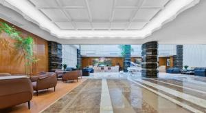 a lobby with couches and chairs in a building at Lake Piedmont International Hotel in Guangzhou +233 photos