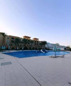 a swimming pool with a slide in a resort at ParadiseHotel in Banī Ghālib
