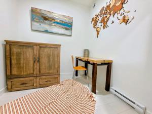 a bedroom with a desk and a wooden cabinet at 2 bedroom heart of Central Surrey in Surrey