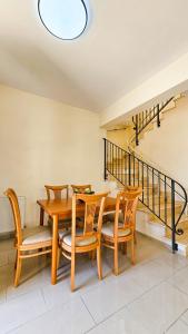 a dining room with a wooden table and chairs at Townbeach Villa with Private Pool in Voroklini