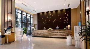 a lobby with a large wall with gold butterflies at Atour Hotel Chengdu High-Tech Zone in Chengdu