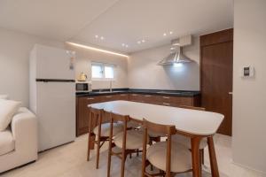 a kitchen with a table and chairs and a refrigerator at Harujae Myeongdong in Seoul
