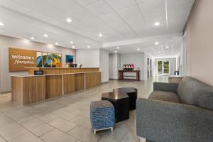 a lobby of a waiting room with a couch and a counter at Hampton Inn & Suites Port Richey in Port Richey +42 photos