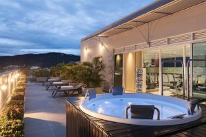 a bath tub on the deck of a house at Hampton By Hilton Yopal in Yopal +30 photos