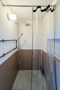 a shower with a glass door in a bathroom at epilogue hotel 302 in Fukuoka