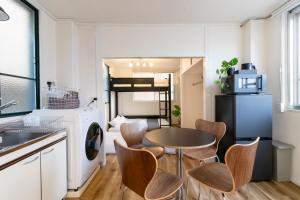 a kitchen with a table and chairs in a room at epilogue hotel 302 in Fukuoka