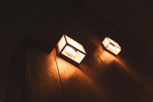 two lights on a wall in a dark room at Karabiner House Myoko in Myoko +29 photos