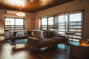 a living room with a couch and a table at Karabiner House Myoko in Myoko