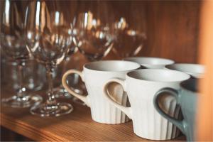 a group of cups and wine glasses on a table at Karabiner House Myoko in Myoko