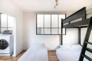 a bedroom with two beds and a washing machine at epilogue hotel 302 in Fukuoka +5 photos