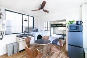 a kitchen with a table and some chairs in a kitchen at epilogue hotel 302 in Fukuoka