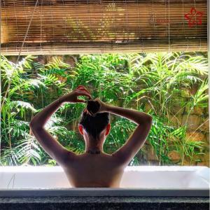 a shirtless man sitting in a window combing his hair at Lahana Resort Phu Quoc & Spa in Phu Quoc +32 photos