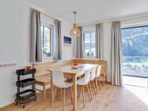 a dining room with a wooden table and chairs at Modern Chalet in Mühlbach am Hochkönig near Ski Area in Mühlbach am Hochkönig +38 photos