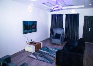 a living room with a couch and a chair at Shepherd Spring Apartments in Gbogije