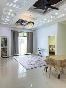 a large living room with a table and chairs at CHAM Homestay PCB in Kota Bharu +11 photos
