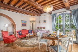 a living room with a table and chairs at Villa MonteLandi in Montalcino +59 photos