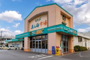 a store front of a building with signs on it at 本部町 最大12名宿泊可 無料駐車場2台付き 家族 グループに最適 Terrace Motobu in Motobu