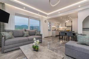 a living room with a couch and a table at Villa Orizzonte - Ground Floor Apartment with shared pool & amazing view in Keri