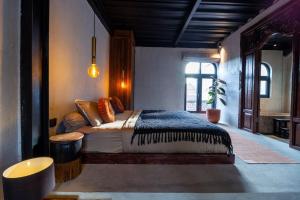 a bedroom with a large bed in a room at Warehouse Loft - Chic industrial aesthetic loft in Dalung +10 photos