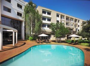 a large swimming pool in front of a building at Garden Court Eastgate in Johannesburg