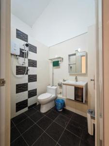 a bathroom with a toilet and a sink at I-homey Residence 1 in Gua Sai +14 photos