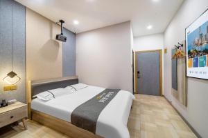 a bedroom with a large white bed in a room at Shanghai Grand View Hotel in Shanghai