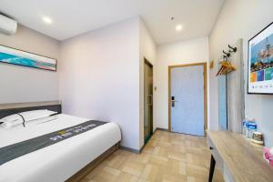 a bedroom with a bed and a blue door at Shanghai Grand View Hotel in Shanghai