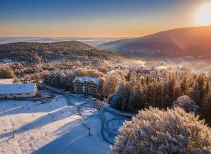 a ski resort in the winter with snow on the ground at Forest Park Resort & SPA in Świeradów-Zdrój