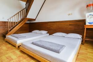 duas camas num quarto com uma escada em Villa TB Pangalengan Bandung RedPartner em Palayangan mais 24 fotografias