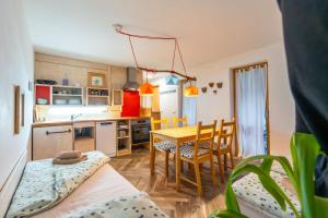 a kitchen and dining room with a table and chairs at Rest And Ride in Robidišče