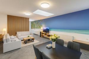 a living room with a table and a view of the ocean at Ideal for Big Groups, Modern 14 Guest Apartment Near Prague in Rakovník