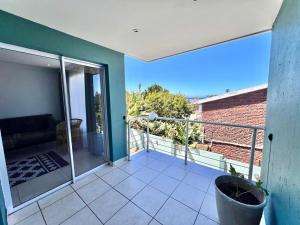 a balcony of a house with a view at Sea la vie at Jbay in Jeffreys Bay +4 photos