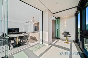 a kitchen and dining room with glass walls and a table at Bright & Spacious 2BR in Prime CBD Location in Perth
