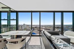 a view from the top of a building with a table and chairs at Bright & Spacious 2BR in Prime CBD Location in Perth