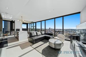 a living room with a couch and a table at Bright & Spacious 2BR in Prime CBD Location in Perth